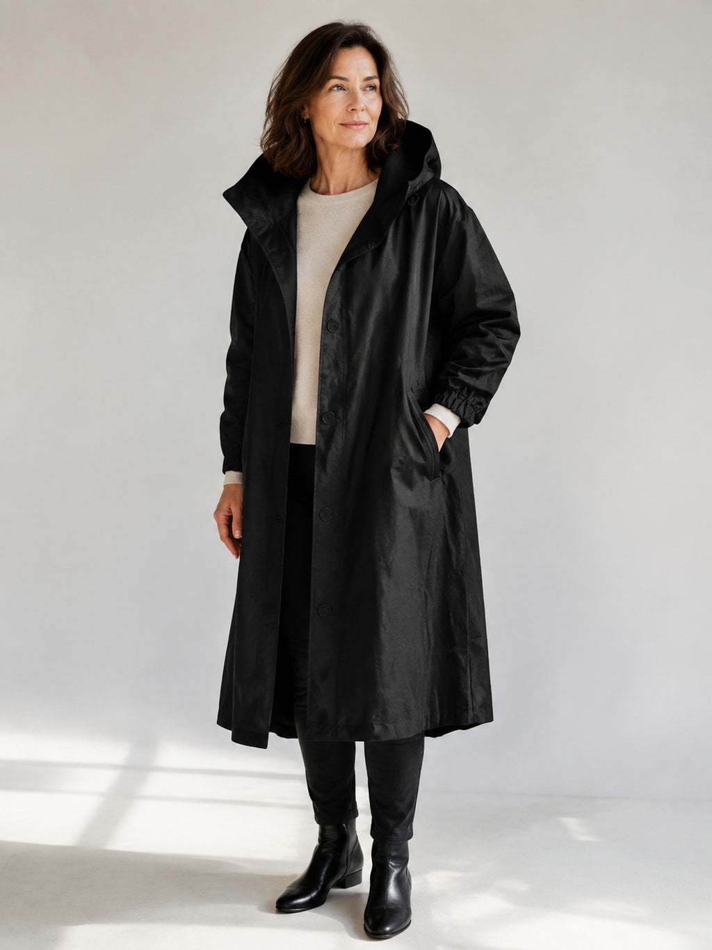 Theodora Hooded Longline Trench Coat in Black on a 40+ model, front view