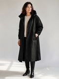 Theodora Hooded Longline Trench Coat in Black on a 40+ model, front view
