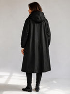 Theodora Hooded Longline Trench Coat in Black on a 40+ model, back view