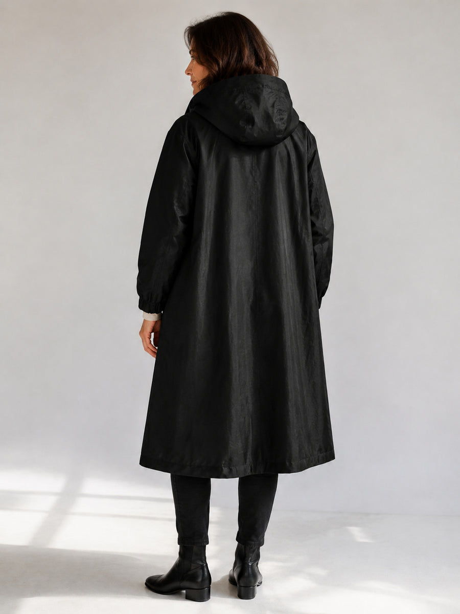 Theodora Hooded Longline Trench Coat in Black on a 40+ model, back view
