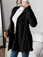 Cora plush hooded longline cardigan in black, worn open over a white top