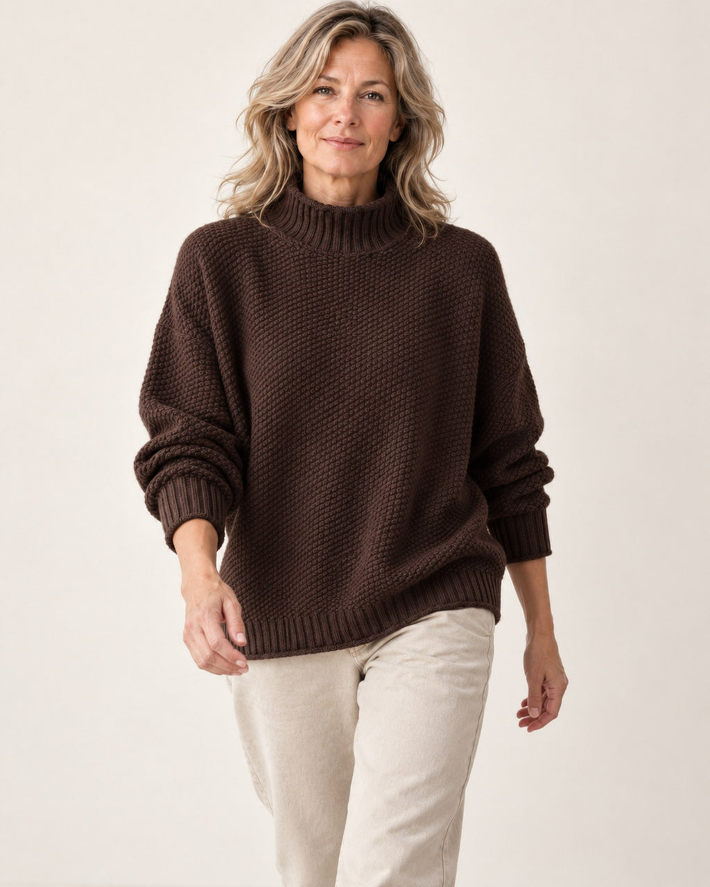 Dorothy knitted sweater in brown, front view while walking