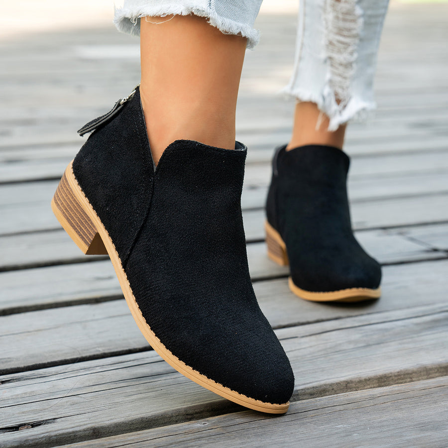 Marlowe comfort low-heel ankle boots in black, worn with cropped jeans, side view showing the back zip