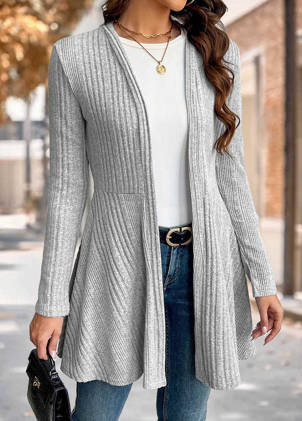 Woman wearing the Nora comfort knit open front cardigan in grey over a white tee and blue jeans, front view