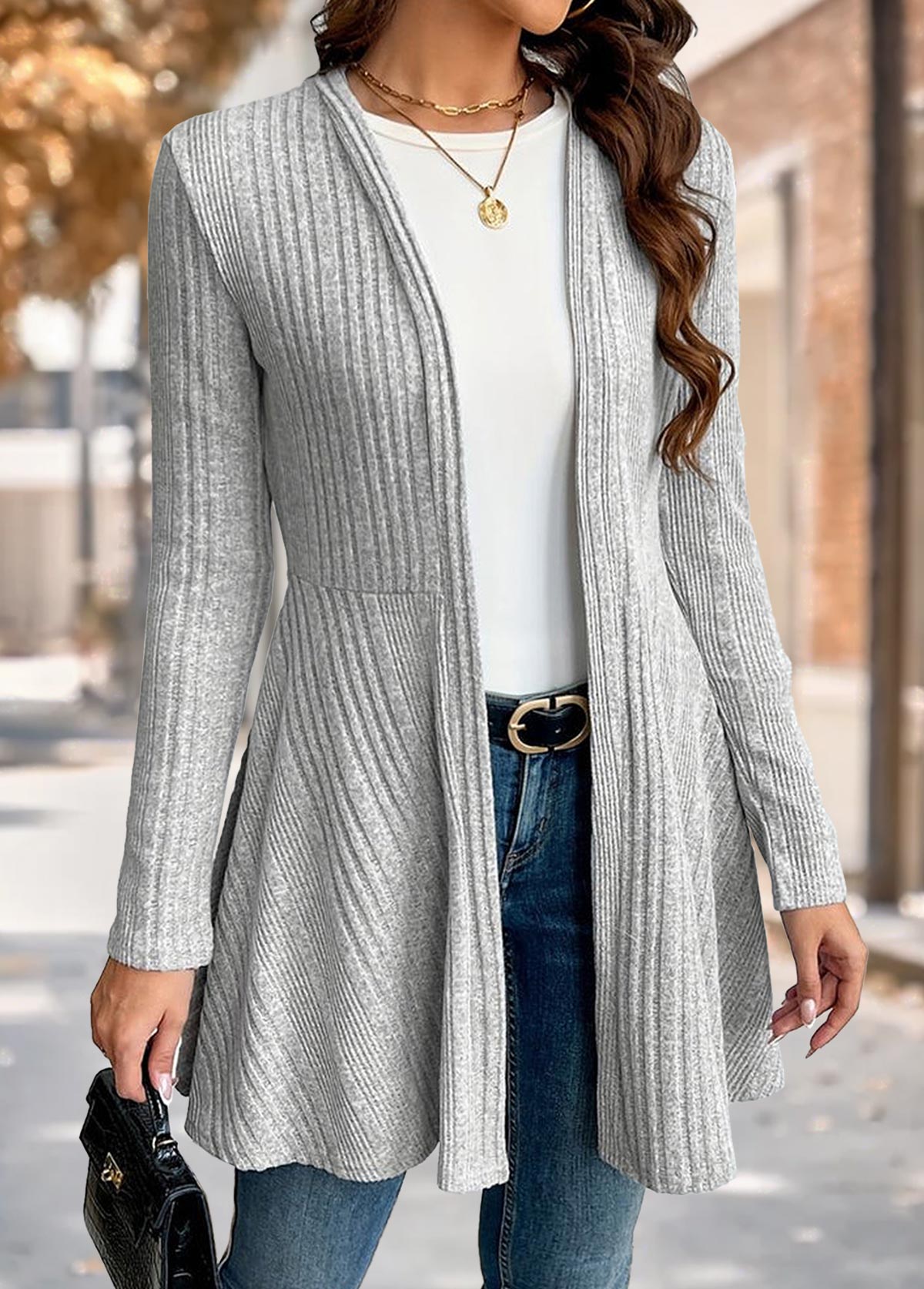 Woman wearing the Nora comfort knit open front cardigan in grey over a white tee and blue jeans, front view