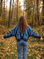 Vivienne butterfly wing cape cardigan in blue, back view worn with jeans