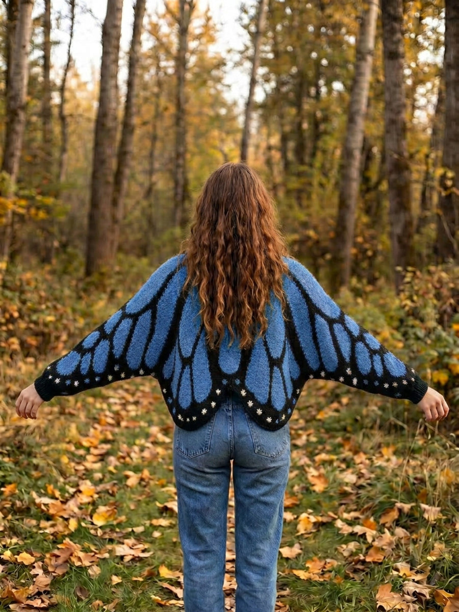 Vivienne butterfly wing cape cardigan in blue, back view worn with jeans