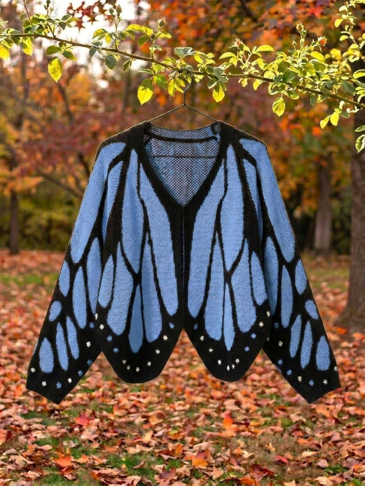 Vivienne butterfly wing cape cardigan in blue, shown open with the full wing pattern